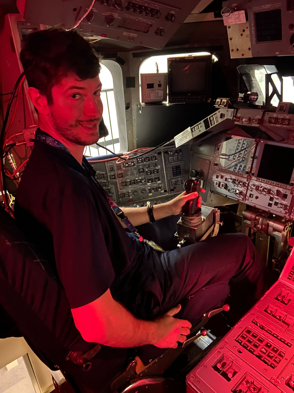 Christos Papageorgakis inside the cockpit of the space shuttle mock-up at Johnson.